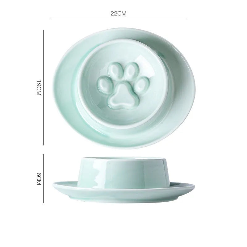 Green ceramic slow feed pet bowl with raised interior ridges and a non-slip black rubber base.
