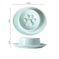 Green ceramic slow feed pet bowl with raised interior ridges and a non-slip black rubber base.