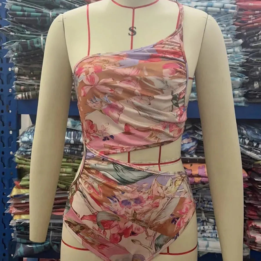 Women's rose gold patterned one-piece swimsuit on hanger