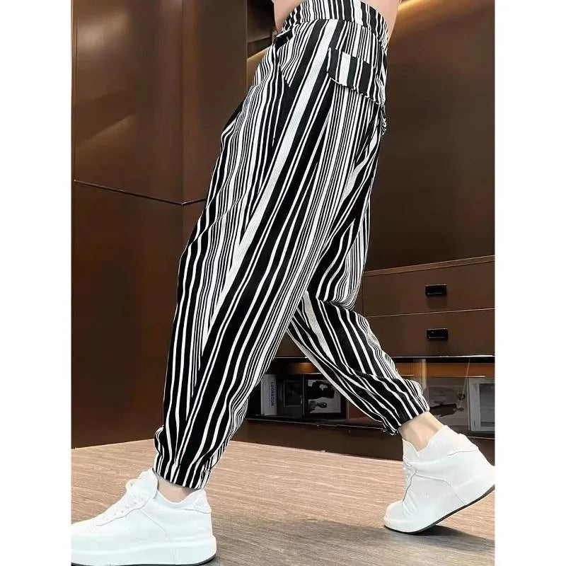 Men's cropped ankle-tied ice silk pants in dark gray stripe pattern, front view on model