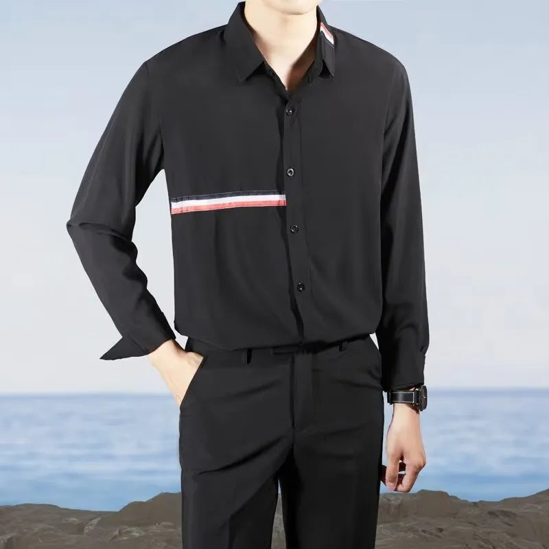 Man wearing a loose fit Hong Kong style casual shirt in a light blue cotton blend fabric.