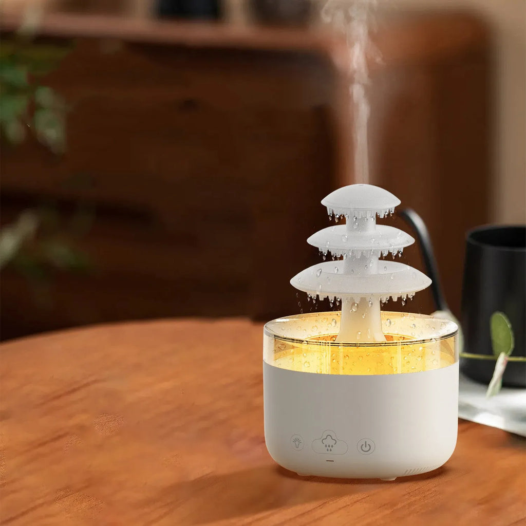White cloud-shaped USB humidifier and essential oil diffuser with LED lights on a table