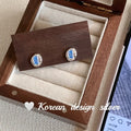 S925 sterling silver oval blue diamond heart-wrapped geometric earrings with electroplated silver finish