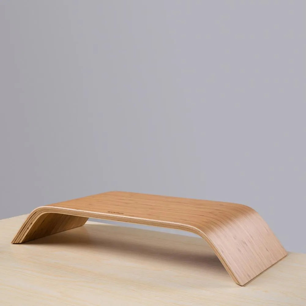 Walnut stability bracket laptop stand in bamboo leather colour, 23x51x9cm, on a desk