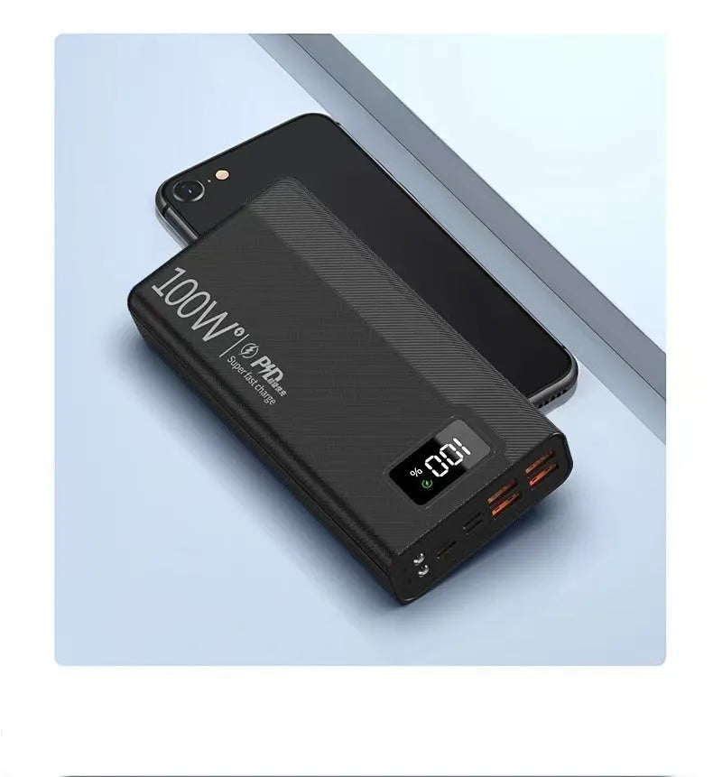 Large black and white power bank showing size comparison next to a mobile phone.