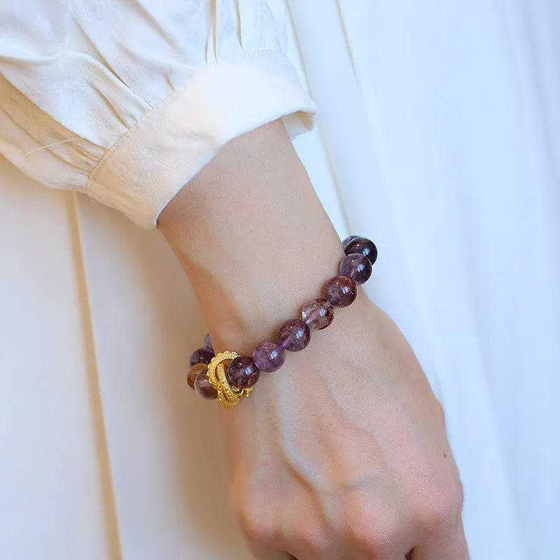 Purple cornucopia nine purple good luck crystal bracelet with zodiac animal motifs on wrist