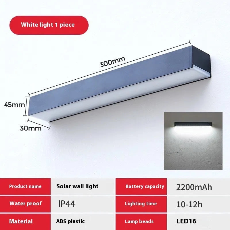 Black solar-powered outdoor wall lamp with IP65 rating for garden installation