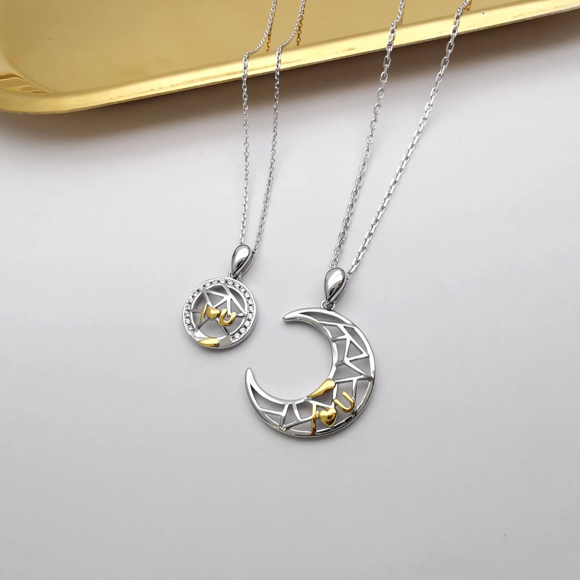 Sun and moon tooth couple necklace set with copper electroplated pendants and cross chain.