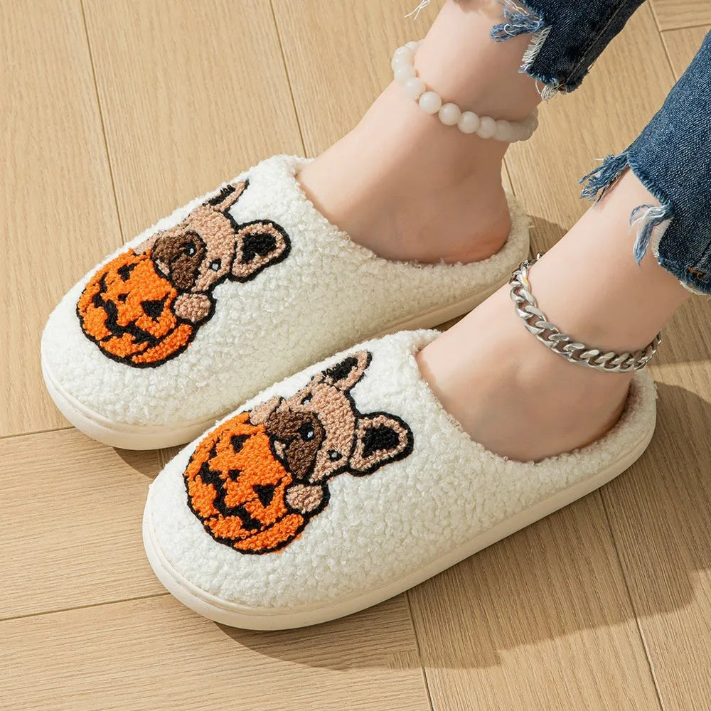 Black and white plush Halloween slippers with pumpkin pattern, round toe, and textured TPR sole.