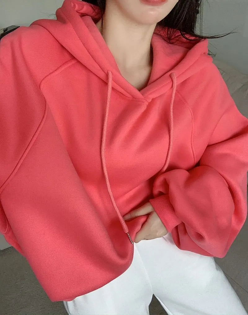Watermelon red mulberry silk hooded sweater on a hanger, showing loose sleeveless fit.