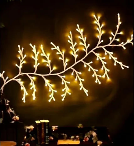 Flexible white birch texture LED vine garland with warm white lights bent into a decorative shape.