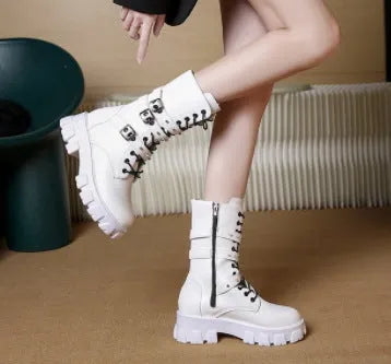 Black women's mid-calf boots with metal buckles and a side zipper on a white background.