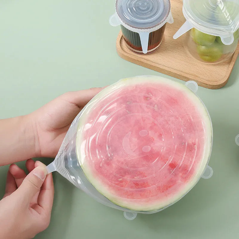 Set of six colourful silicone stretch lids in different sizes for covering bowls and food containers.