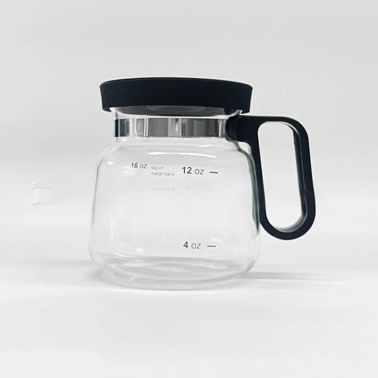 Transparent borosilicate glass coffee maker with black silicone lid on a stovetop