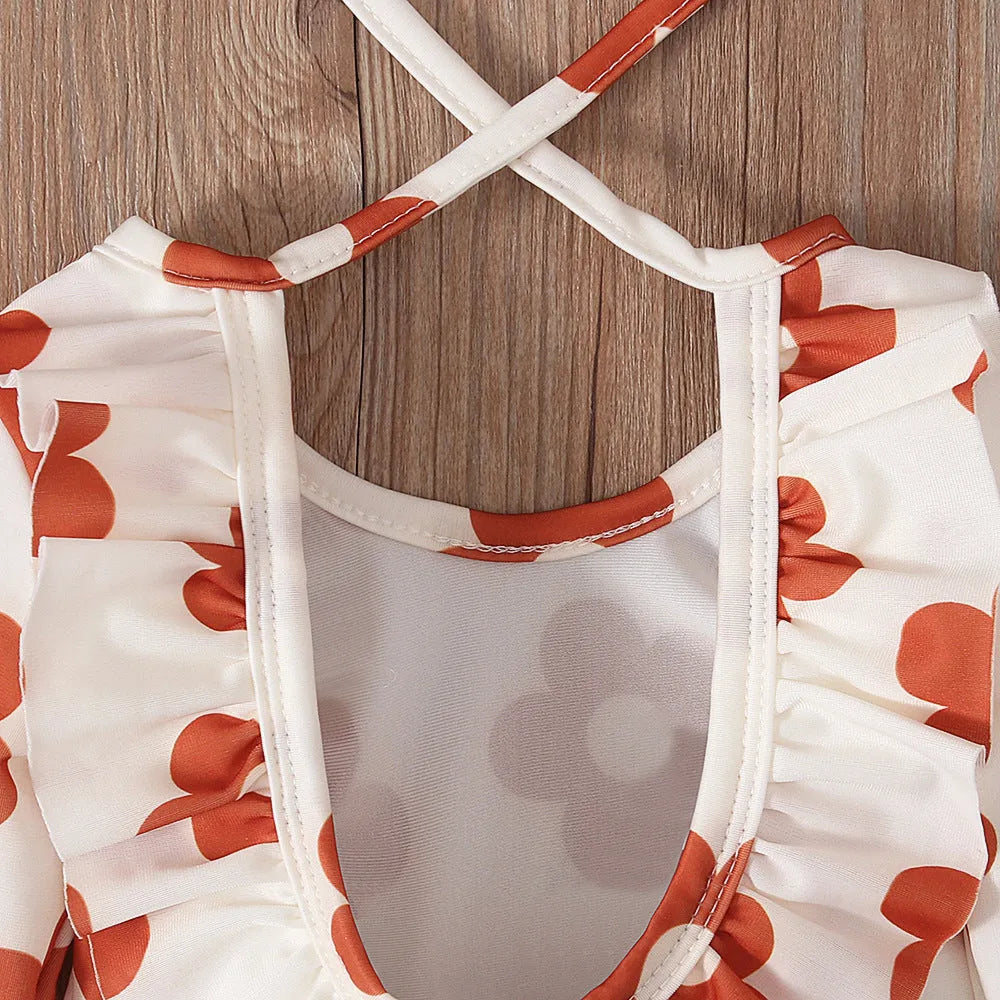 Girls floral print swimsuit with crew neck front and open back in orange colour