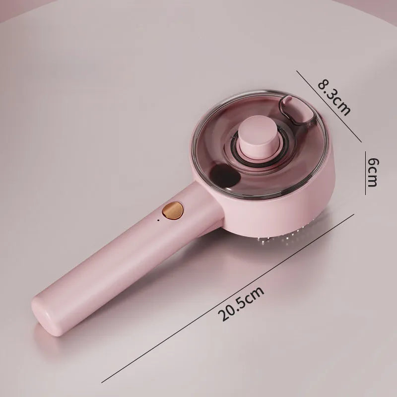 Pink and white cat steam brush with water tank, stainless steel comb, and control buttons for mist and cleaning.