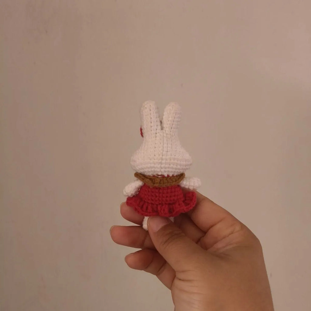 Hand-crocheted wool rabbit key chain with cute design, shown in two style options