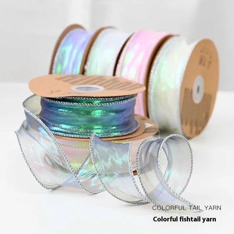 Roll of colourful wave patterned fishtail yarn decorative ribbon in mesh material, 4cm wide.