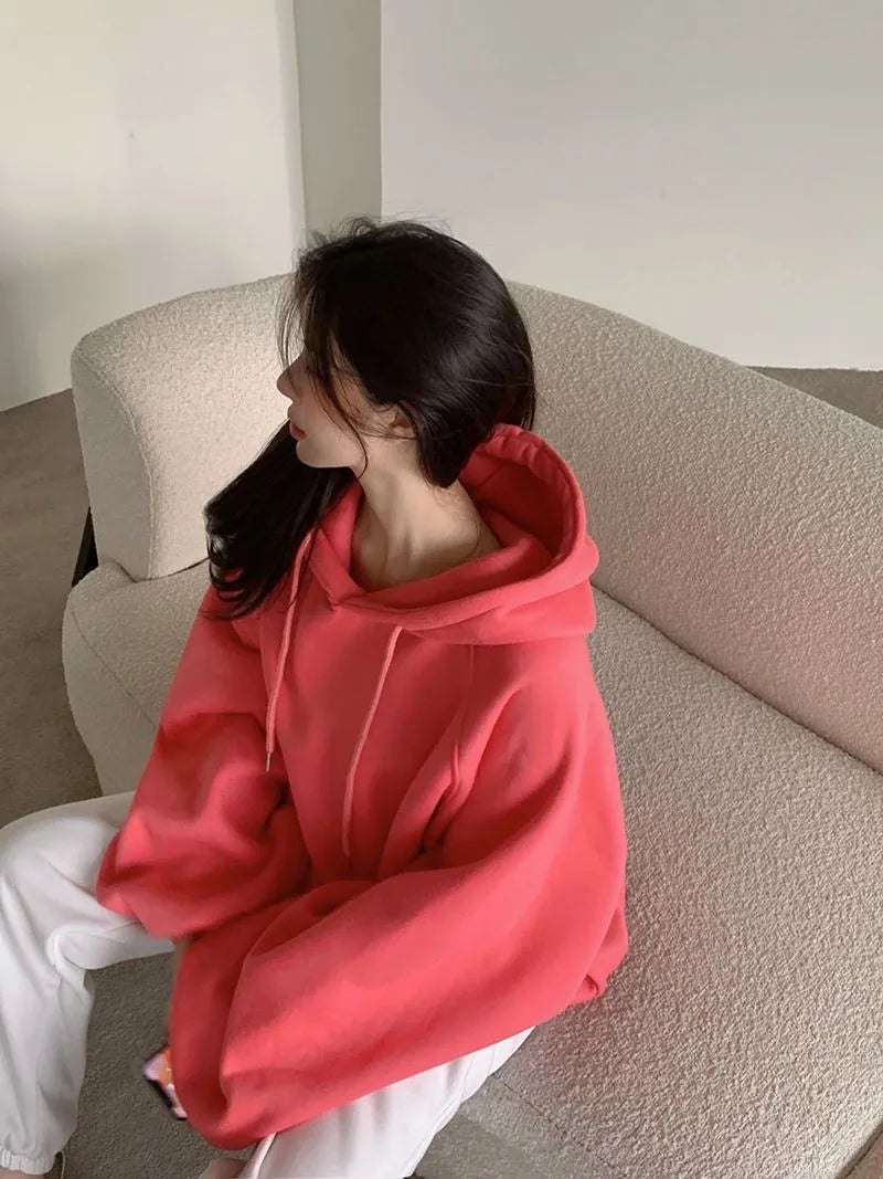 Watermelon red mulberry silk hooded sweater on a hanger, showing loose sleeveless fit.