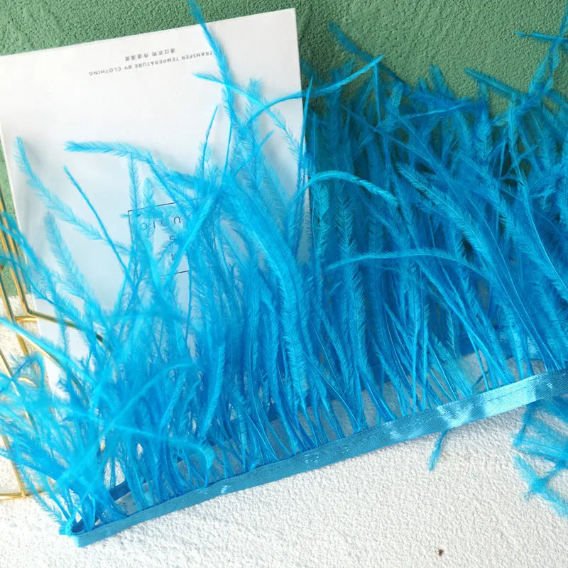 Decorative feather cloth strip in multiple colours including white, black, and mint green for DIY clothing and craft projects