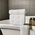 White bathtub pillow with 4D mesh fabric and seven suction cups on a bathtub.