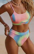 Women's orange and blue tie-dye pleated bikini set on a white background.