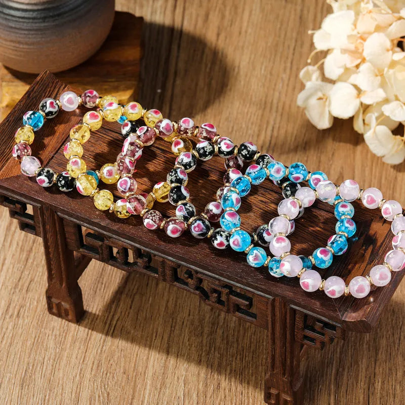 Handmade heart-shaped glass bead bracelet with ancient fluorescent glaze and swallowing gold beast design