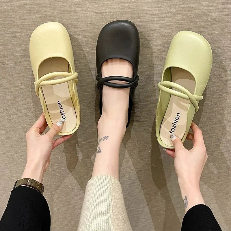 Women's black plastic toe cap flip-flop sandals on a white background.