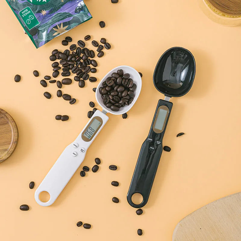 White digital kitchen spoon scale with LCD display showing weight measurement