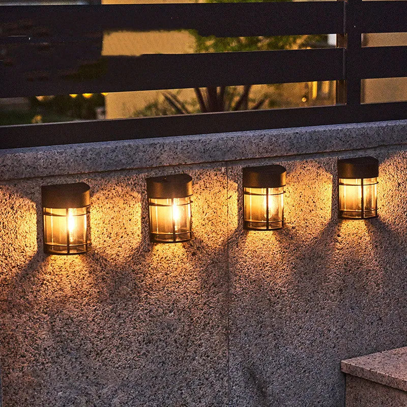 Set of 6 solar-powered outdoor wall lights with warm white illumination mounted on a garden wall