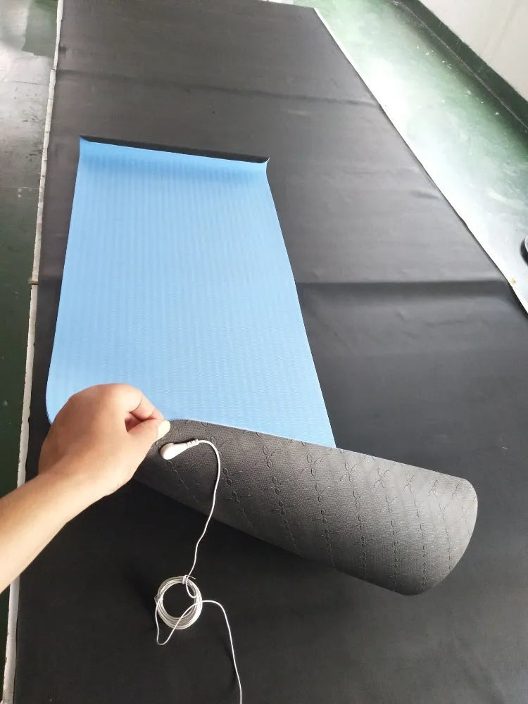 Blue conductive yoga mat with floral pattern, grounding wire, and non-slip surface.