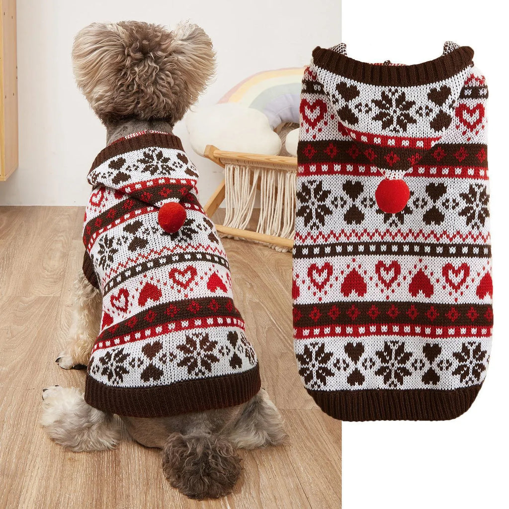 Blue knitted dog sweater with white snowflake and love heart patterns on a striped camouflage background.