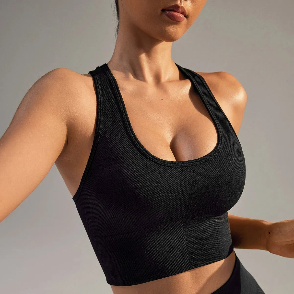 Black women's sports bra with a cross beauty back design and double shoulder straps.
