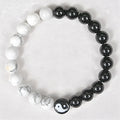 Natural obsidian and white turquoise 8mm bead bracelet on a neutral background
