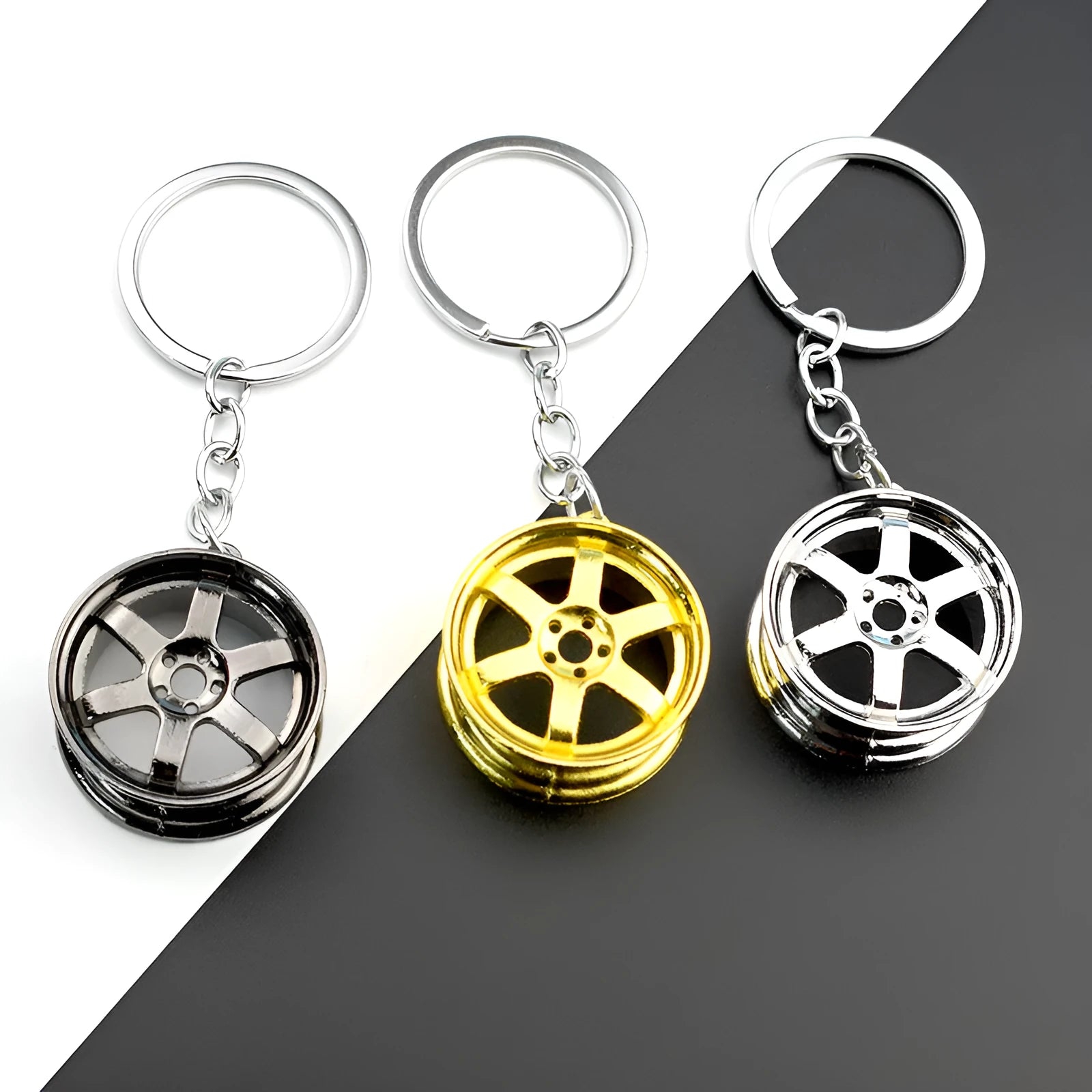 Zinc alloy car wheel hub keychain in gold, silver, and black colour options.