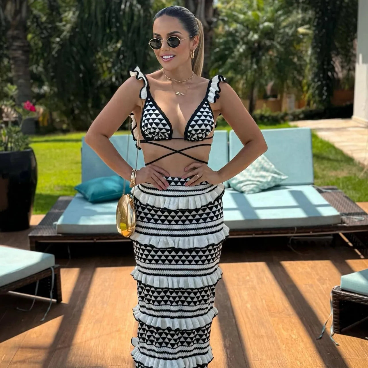 Women's black and white striped bikini top with ruffles and matching long knitted skirt set