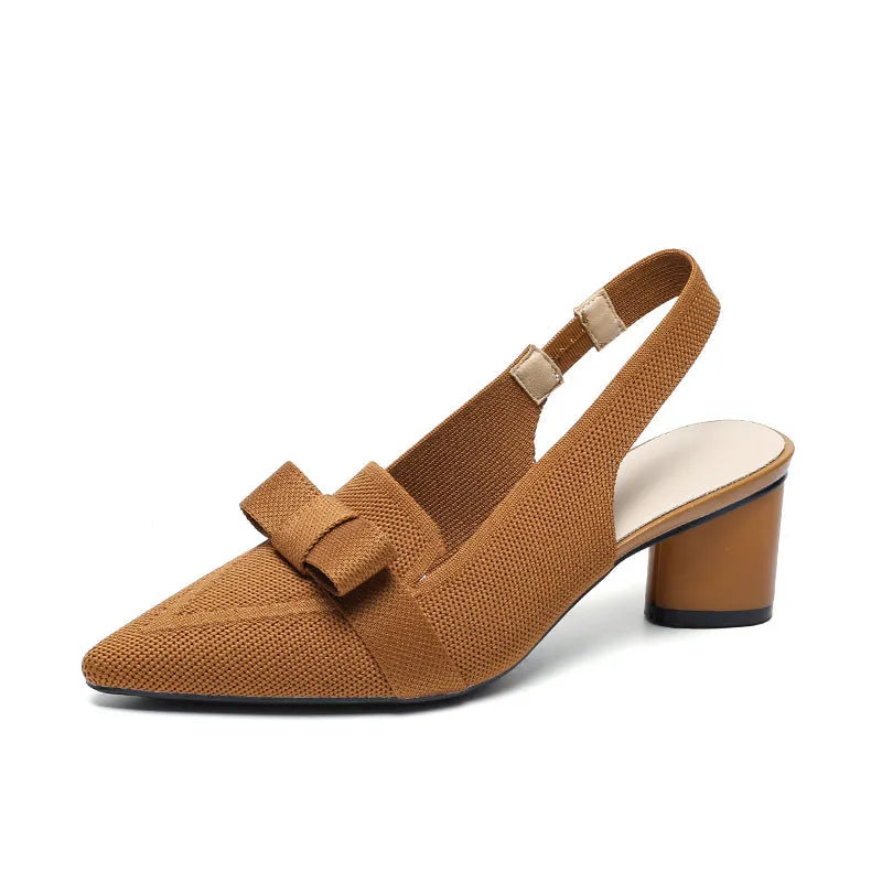 Women's black closed toe high heel sandals with a bow detail and an ankle strap on a rubber sole.