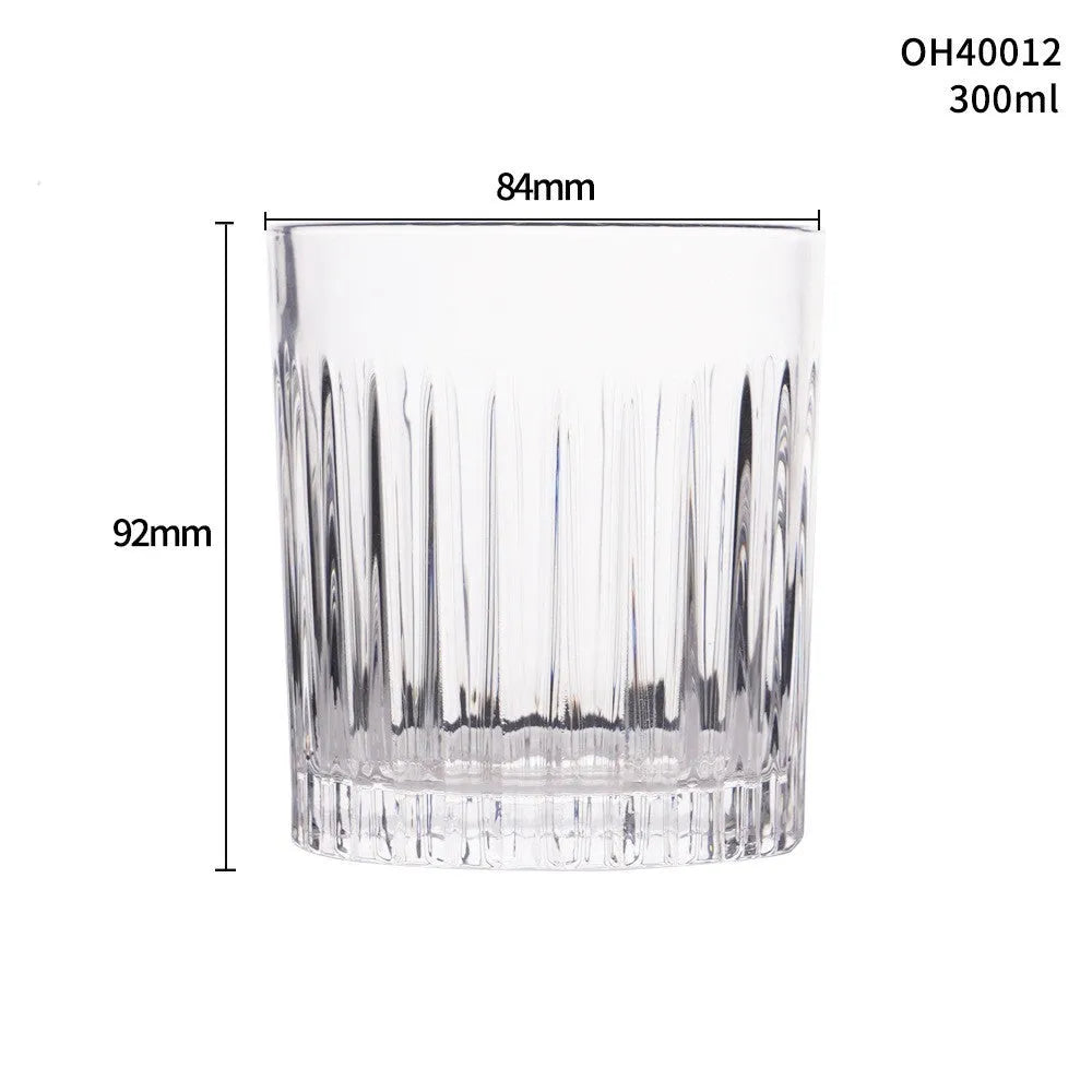 Clear crystal whiskey shot glass with thick bottom base on a table.