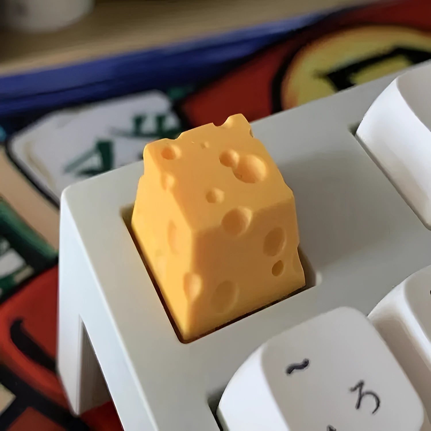 Yellow resin cheese-shaped key cap for mechanical keyboards, shown from a top-down angle.