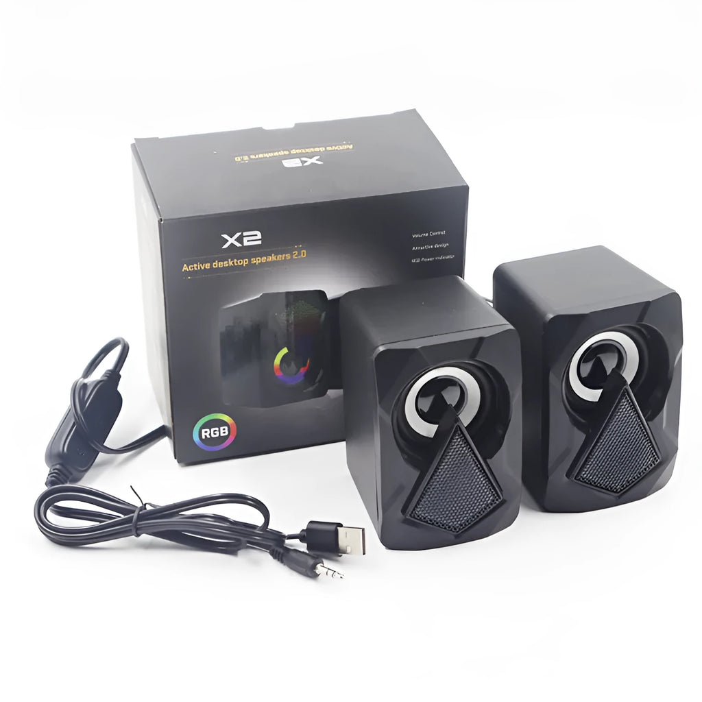 X2 RGB USB desktop multimedia speaker pair with extra bass, wired connection, and colourful lighting on a desk