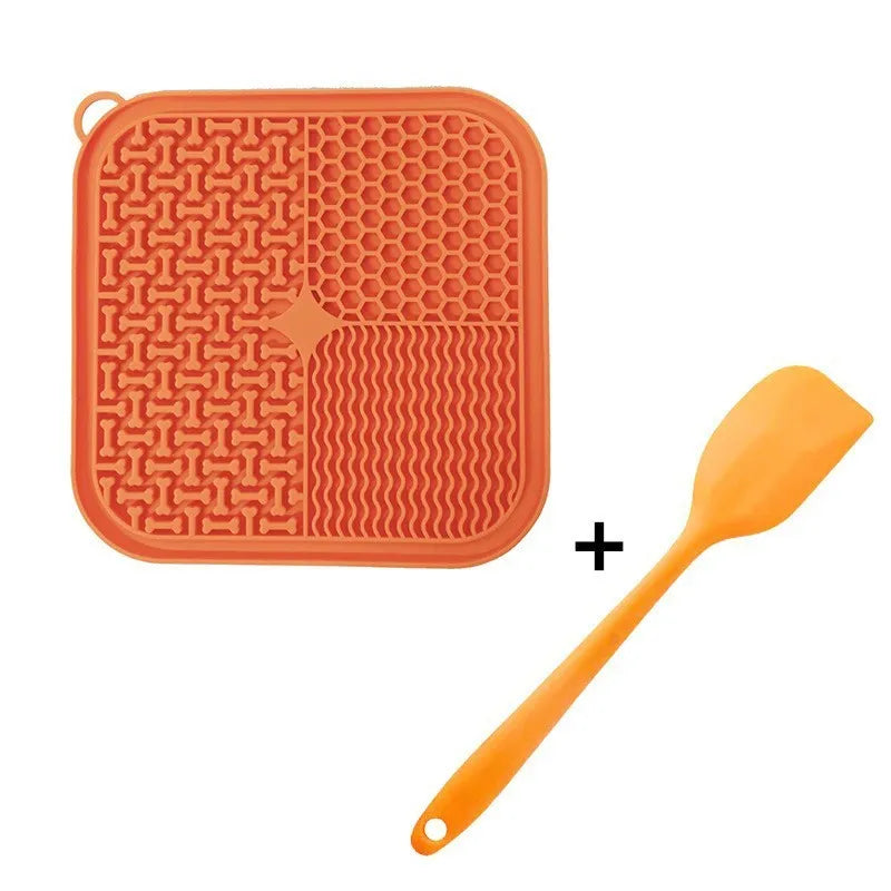 Orange, grey, blue and green silicone dog licking mat with suction cups on back measuring 20x20cm