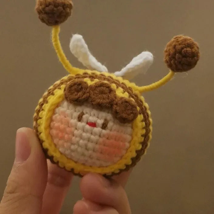 Handmade crocheted bee colony wool doll with bee pendant accessory in plush soft toy construction