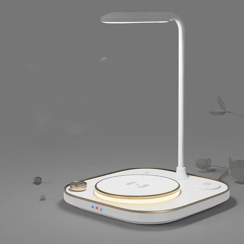 Black three-in-one wireless magnetic charging station with desk lamp and cable on a wooden desk.