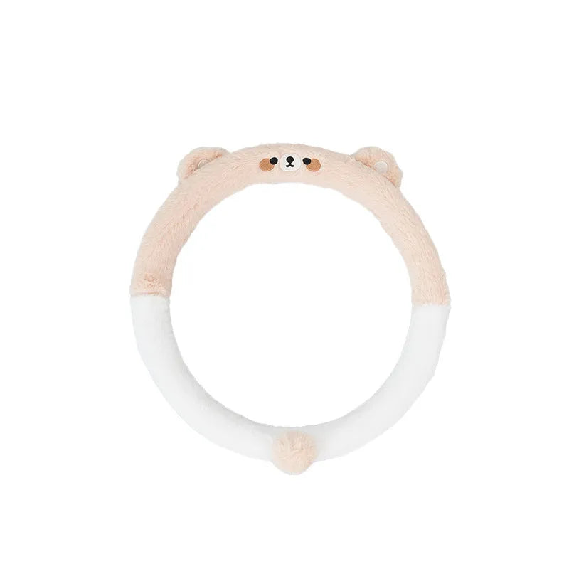 Plush rabbit fur style steering wheel cover with embroidered panda design, fitted on a car wheel