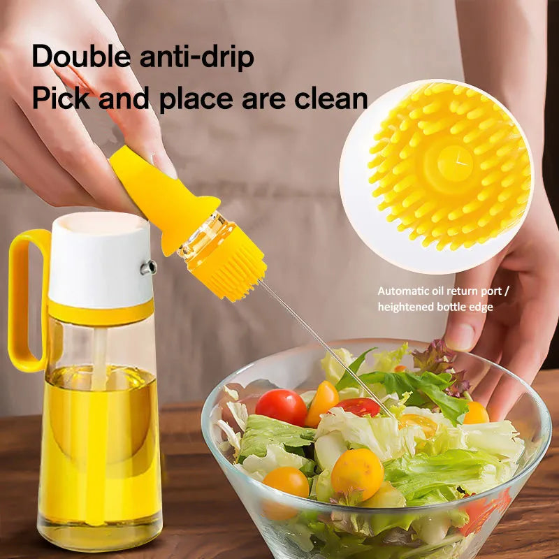 550ml clear glass oil dispenser bottle with stainless steel spray nozzle and a yellow silicone brush head attached.