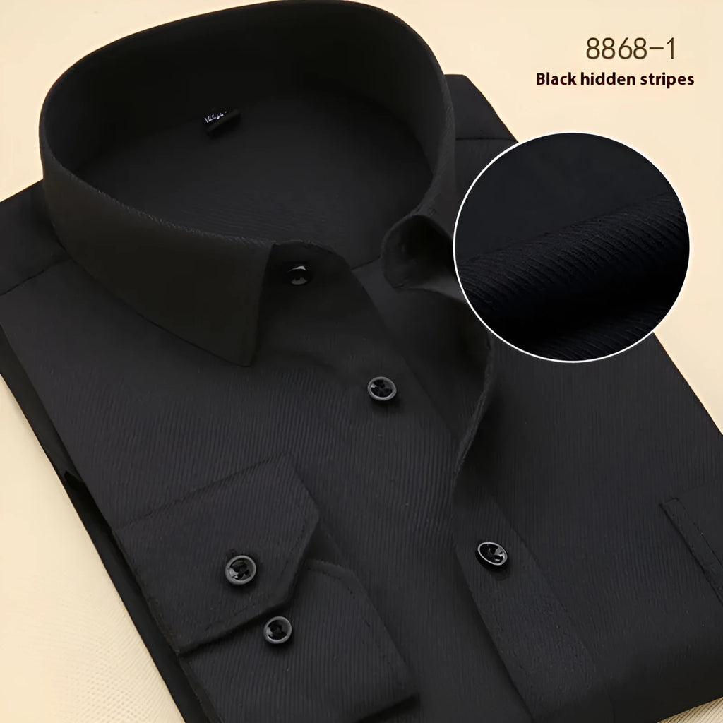 A man wearing a black long sleeve cotton business shirt with a regular slim fit.