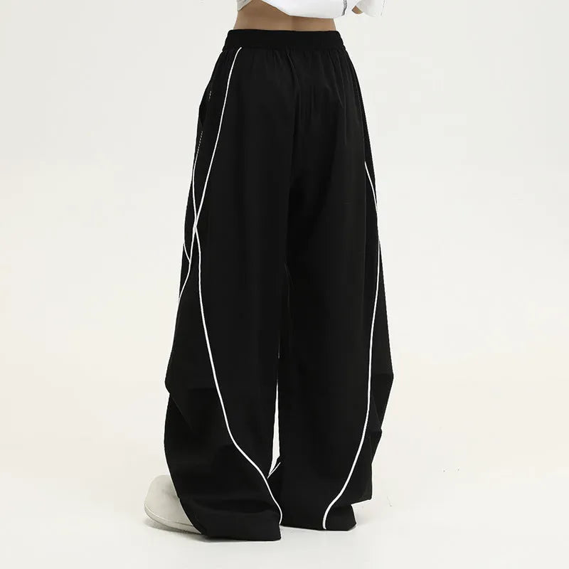 Black pleated wide-leg hip hop sports trousers with striped pattern and elasticated waist.