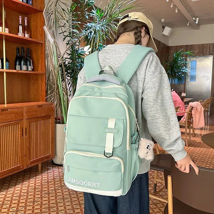 Waterproof nylon high school student backpack in choice of colours, showing pendant and no-pendant styles.