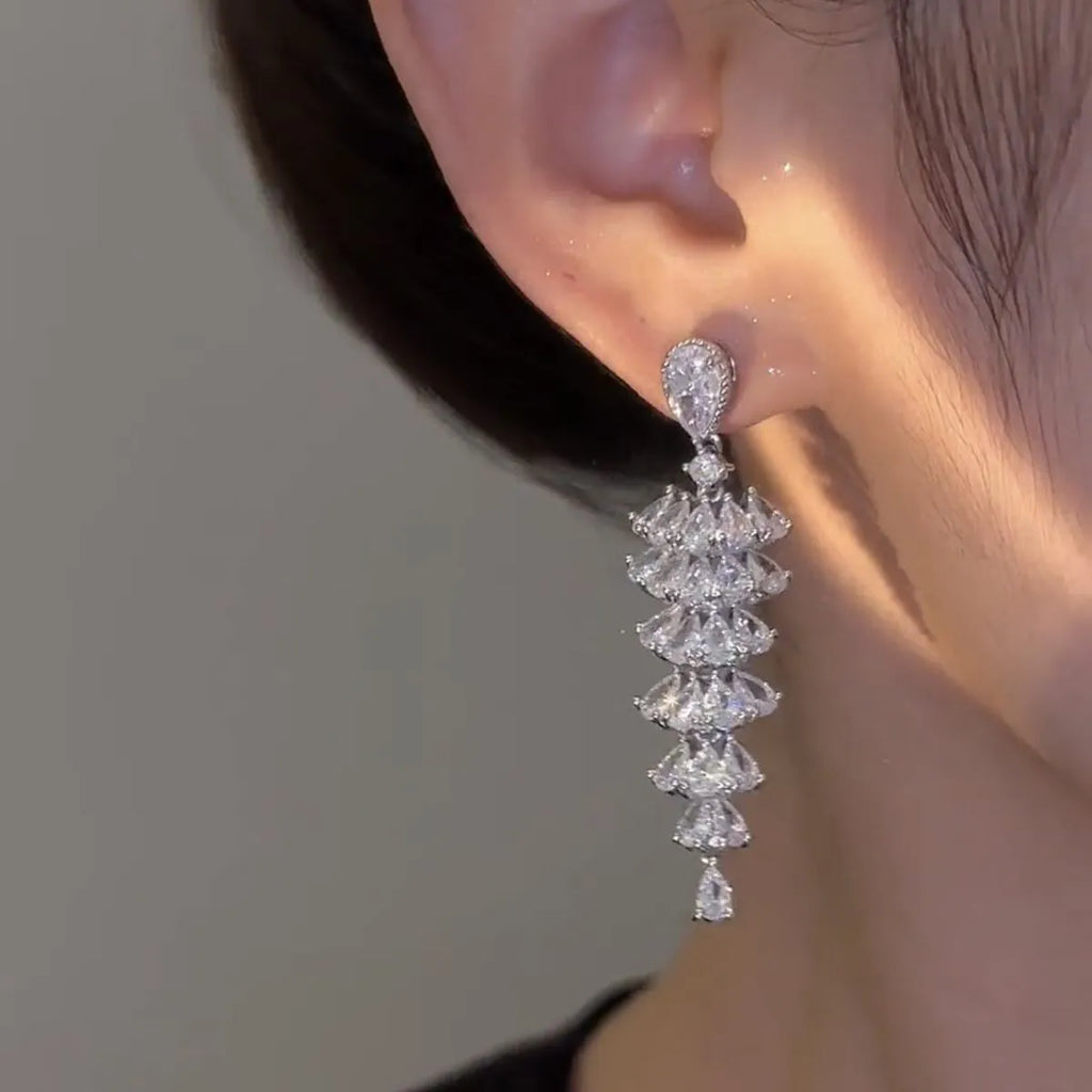 Women's silver pagoda Christmas tree drop earrings with sparkling zircon details on copper.