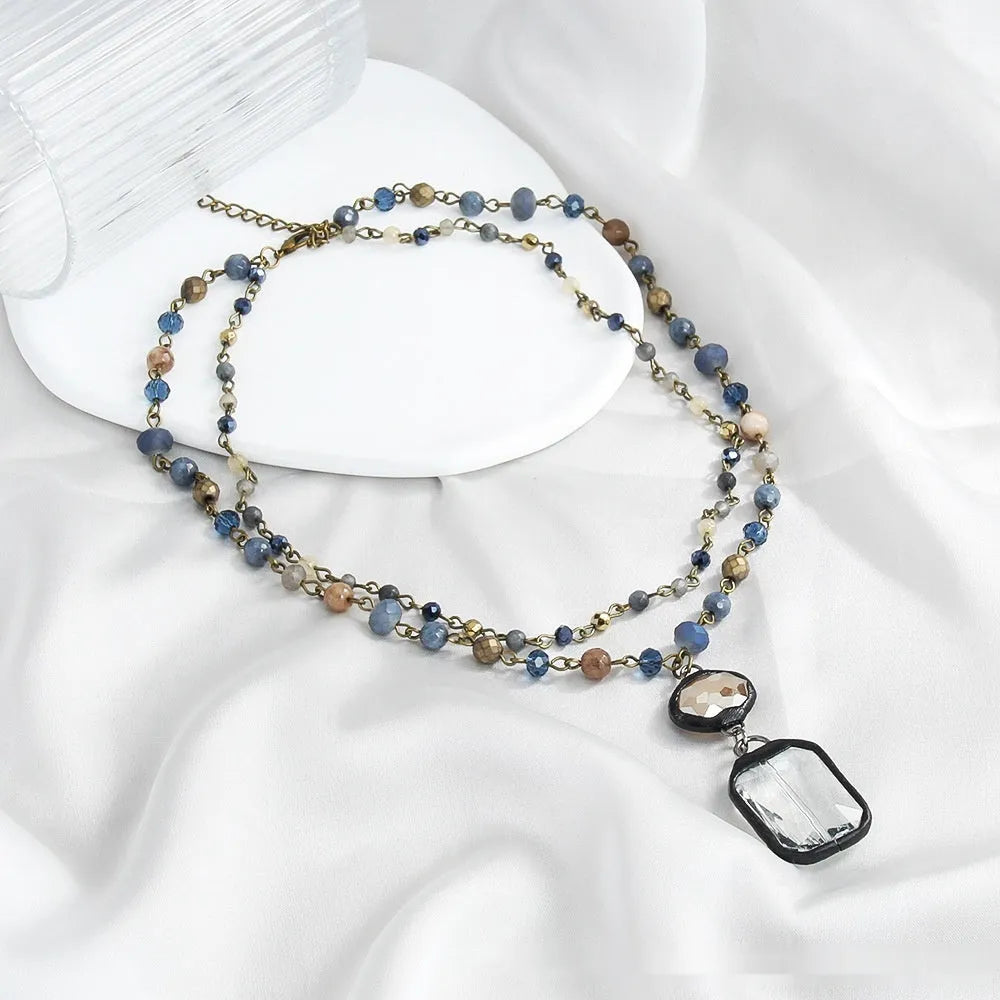 Tribal style two-layer necklace with glass pendant and semi-precious stones on adjustable chain
